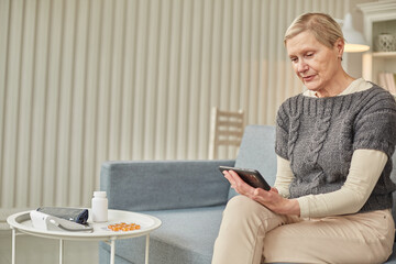Sick woman during a video call with a doctor. Side view of a patient in quarantine during a conference call with his doctor.