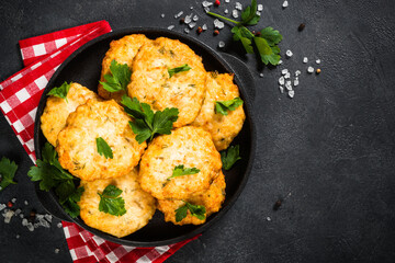 Chicken cutlet at dark table.