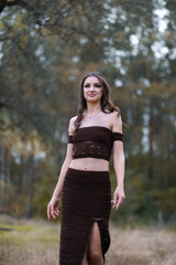 Attractive confident young girl in a beautiful evening dress