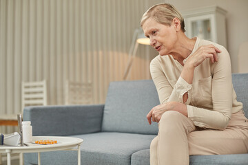 Telemedicine concept. Old woman with tablet during an online consultation with her doctor in her living room