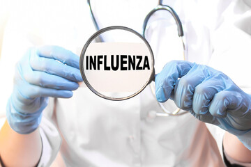 The doctor's blue - gloved hands show the word INFLUENZA - . a gloved hand on a white background. Medical concept. the medicine