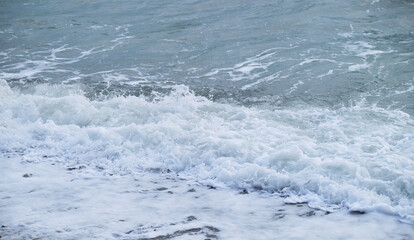 Air is cool and fresh. Minimalistic ocean background. Seascape of gently undulating sea and waves with white foam. Blue and sometimes turquoise cold North Sea.