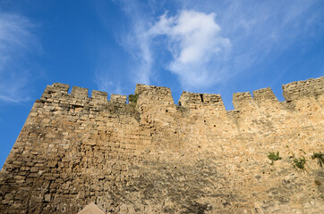 The wall of the old castle in Europe. Medieval fortress. Medieval fortified city. Ancient town.