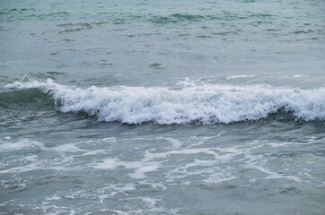 Air is cool and fresh. Minimalistic ocean background. Seascape of gently undulating sea and waves with white foam. Blue and sometimes turquoise cold North Sea.