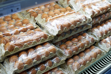 Close up of packaging with chicken eggs on the shelves in the supermarket.