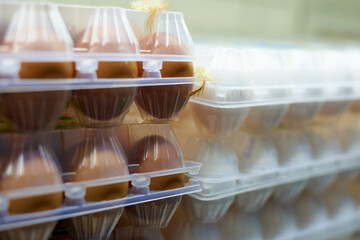 Close up of packaging with chicken eggs on the shelves in the warehouse.