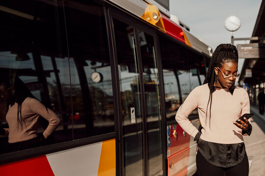 Young woman waiting at bus station