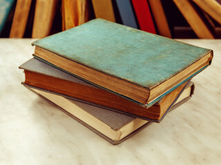 Three old books lie on light table