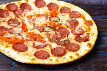 Pepperoni pizza with salami and mozzarellaon wooden table.