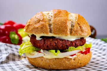 Tasty hamburger made with vegetarian plant based imitation minced meat burger and fresh vegetables