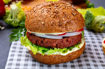 Tasty hamburger made with vegetarian plant based imitation minced meat burger and fresh vegetables