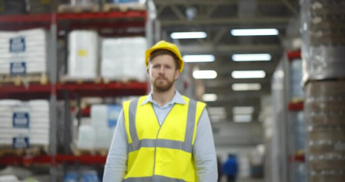 Portrait caucasian warehouse male worker standing with arms crossed and smiling in warehouse