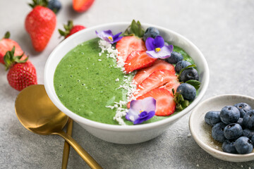 Colorful, healthy food. Acai green smoothie bowl. Keto breakfast idea.