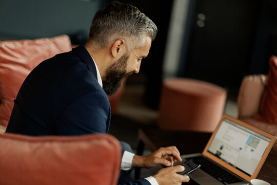 Businessman using cell phone in cafe