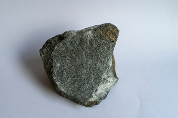 Small broken piece of sandstone on white background.