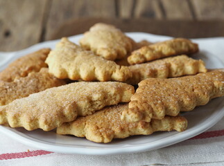 Homemade honey shortbread cookies with carved edges on a wooden background.Healthy natural food.