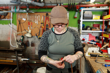 Female plumber working in workshop