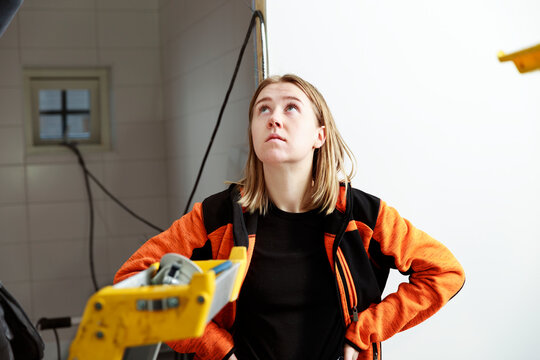 Young woman renovating house