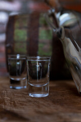 Hard alcoholic drink or brandy from fermented fruits, old wooden table, still life