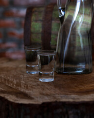 Hard alcoholic drink or brandy from fermented fruits, old wooden table, still life