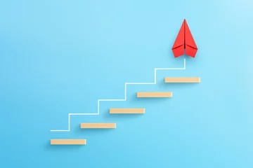 Foto op Canvas Wooden block stacking as step stair with red paper plane on blue background, Ladder of success in business growth concept, copy space © Worawut