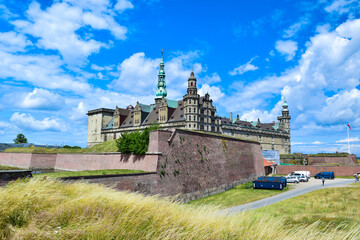 Medieval Kronborg castle on blue cloudy sky background. Fortress is located on Oresund Strait shores of Baltic Sea. Helsingor, island Zealand, Denmark.