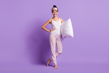 Full length body size photo of girl in pajama keeping white pillow wearing sleeping mask isolated pastel violet color background