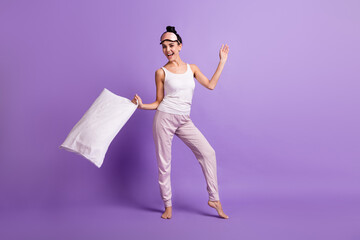 Full length photo of pretty satisfied lady arm hold pillow toothy smile look camera isolated on violet color background