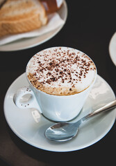 Hot mocha coffee with milk foam and cocoa powder.