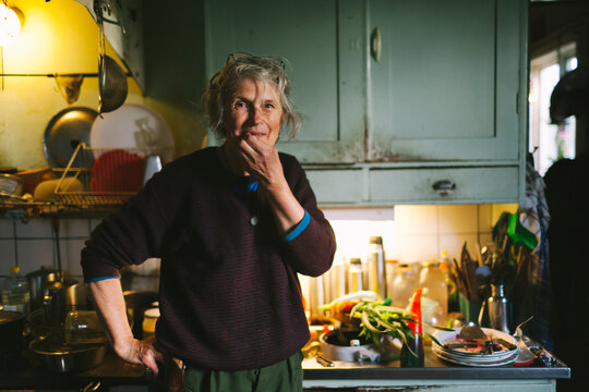 Smiling woman in kitchen looking at camera