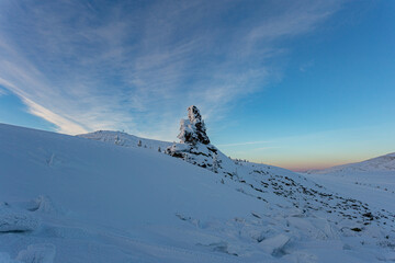 unrealistically beautiful and magical rock shrouded in snow frost. a large stone for conducting...