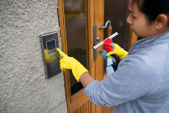 Female cleaner ringing intercom
