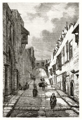 central perspective of stone uphill road among two lines of medieval houses in Street of the Knights, Rhodes. Ancient grey tone etching style art by unidentified author, Le Tour du Monde, 1862