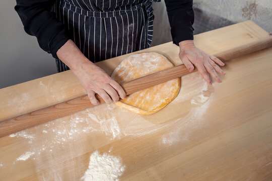 Woman's hands rolling dough