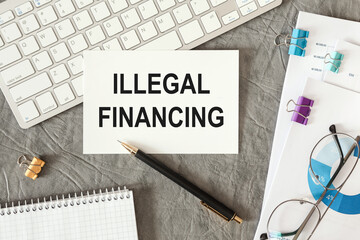 Illegal financing is written in a document on the office desk