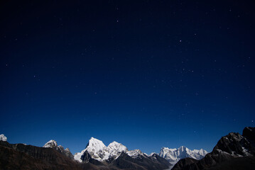 Starry night sky and snow mountains in Himalayas, Nepal