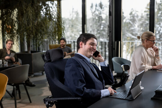 Businessman in cafe talking via cell phone