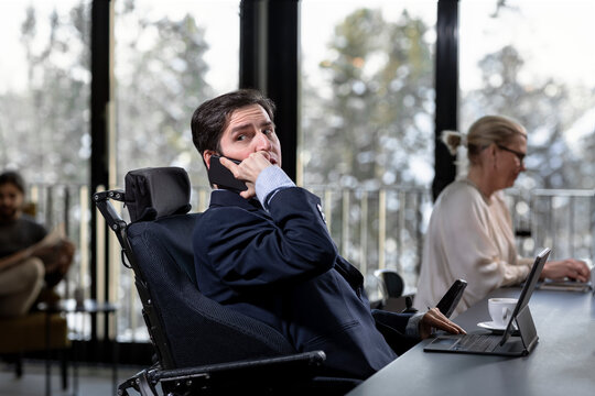 Businessman in cafe talking via cell phone