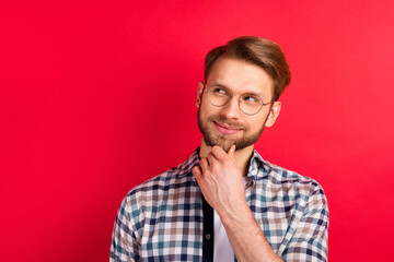 Fototapeta premium Photo of handsome sweet gentleman dressed plaid shirt spectacles arm chin smiling looking empty space isolated red color background