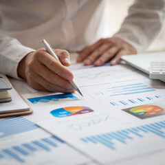 Financial Business man analyze the graph of the company's performance to create profits and growth,...