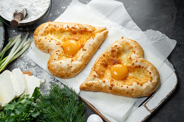 two khachapuri in the shape of a heart. dinner in a Georgian restaurant for two on Valentine's Day