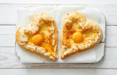 two khachapuri in the shape of a heart. dinner in a Georgian restaurant for two on Valentine's Day