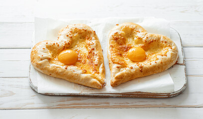 two khachapuri in the shape of a heart. dinner in a Georgian restaurant for two on Valentine's Day