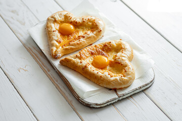 two khachapuri in the shape of a heart. dinner in a Georgian restaurant for two on Valentine's Day