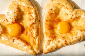 two khachapuri in the shape of a heart. dinner in a Georgian restaurant for two on Valentine's Day