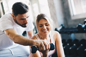 Sporty couple make weight lifting together in loft gym