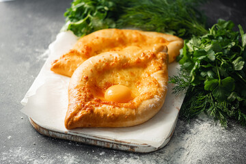 two Adjarian khachapuri in traditional classic Georgian style.