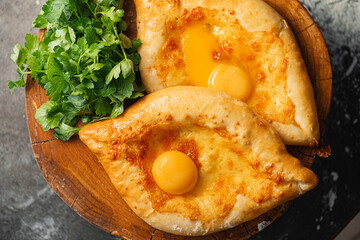 two Adjarian khachapuri in traditional classic Georgian style.
