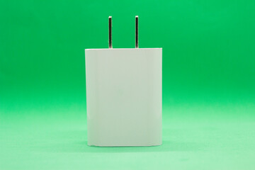 Separate phone charger on green background