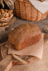 Obraz na płótnie Canvas Loaf of traditional rye bread on wooden background